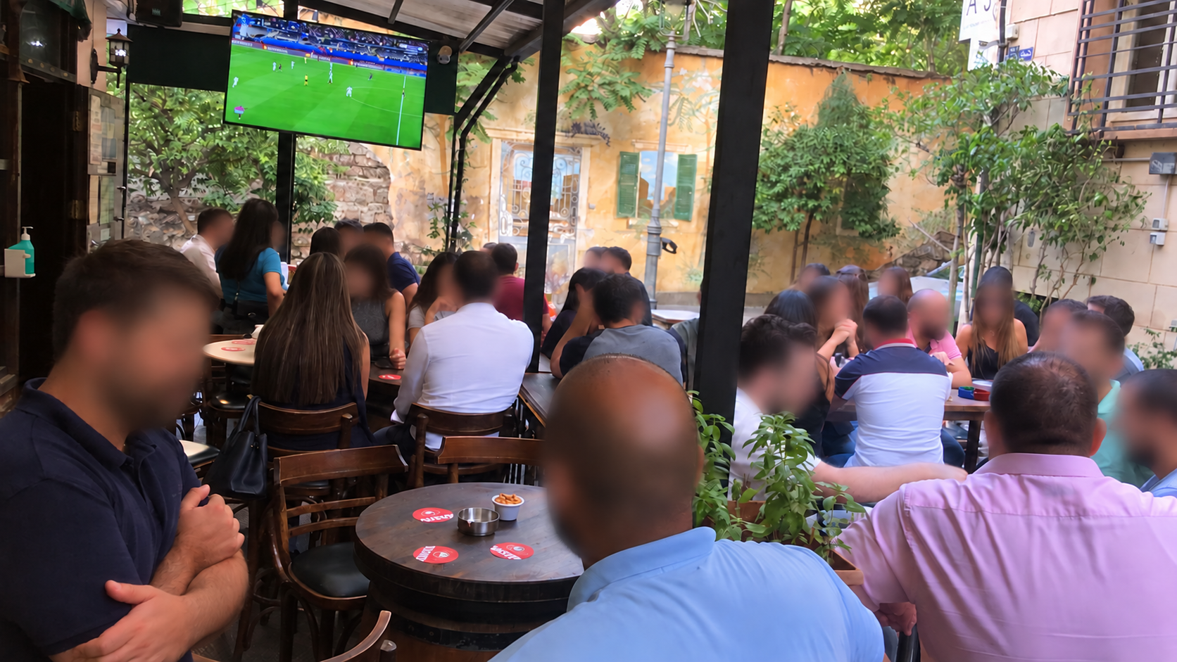 Guests watching live football from the busy outdoor terrace at Celtic Irish Bar